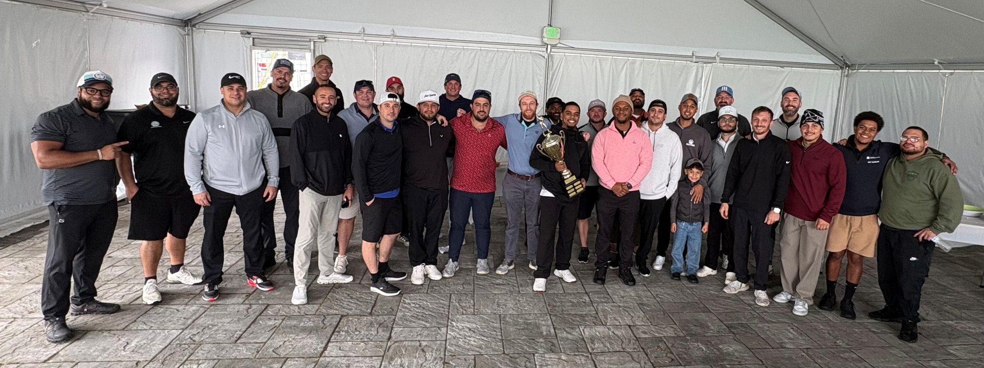 New Era Plumbing 3rd Annual Golf Outing 2026 golfers and the tournament trophy under a tent at Flanders Valley Golf Course