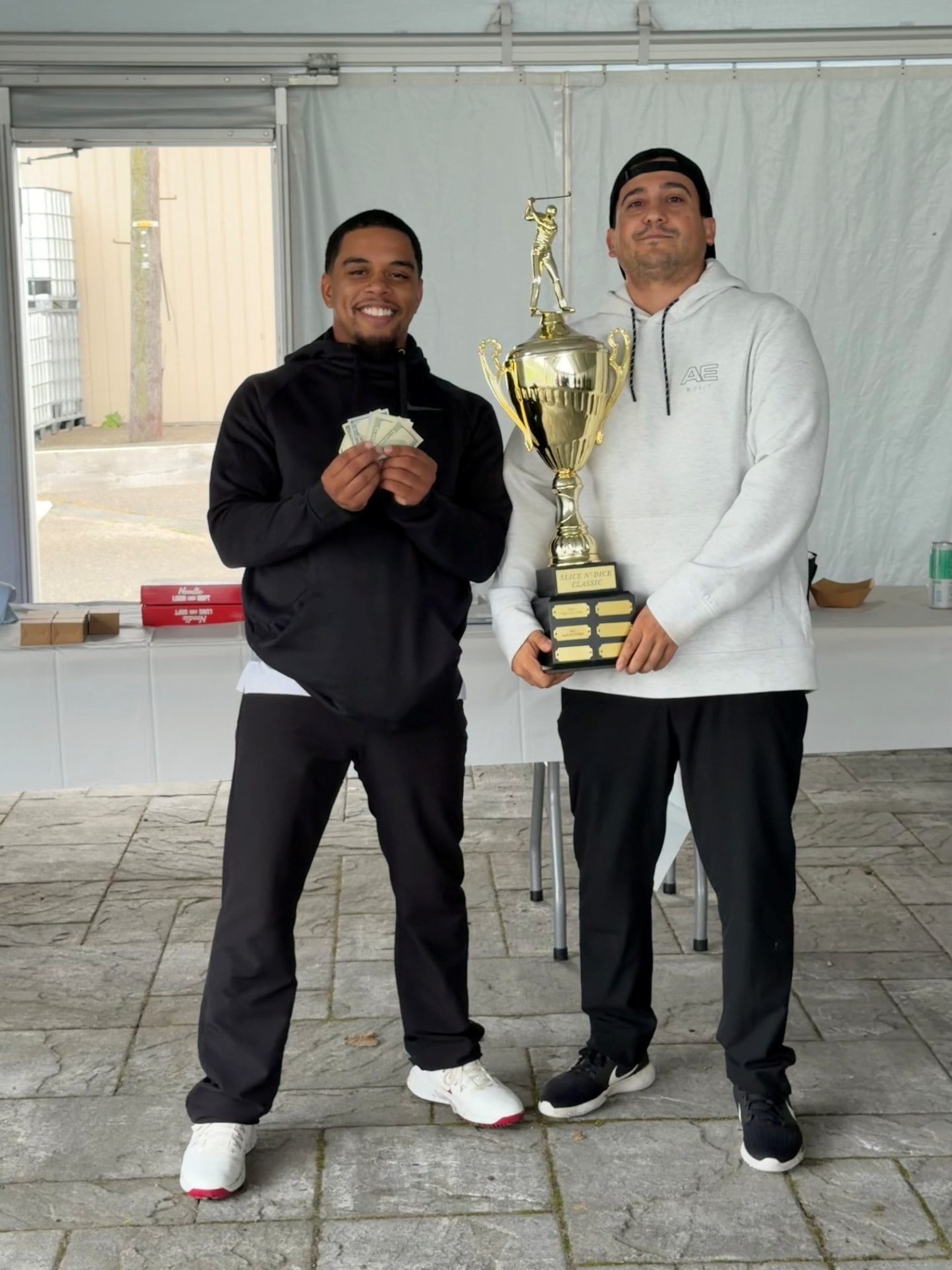 Winners of the New Era Plumbing 3rd Annual Slice and Dice Classic golf outing holding the trophy